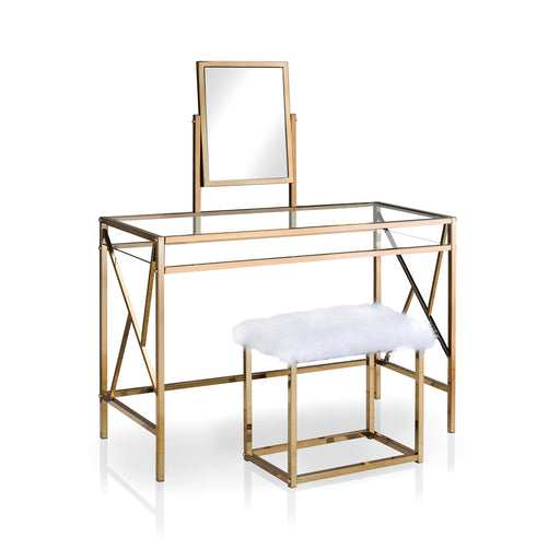 Right angled champagne vanity set against a white background. The table comes with an attached rotating rectangular mirror. A glass top is paralleled with a shelf to maintain an open and airy design. Continuing the chic look are two legs on each side joined by a geometric bar design. A champagne stool is upholstered in white faux fur.