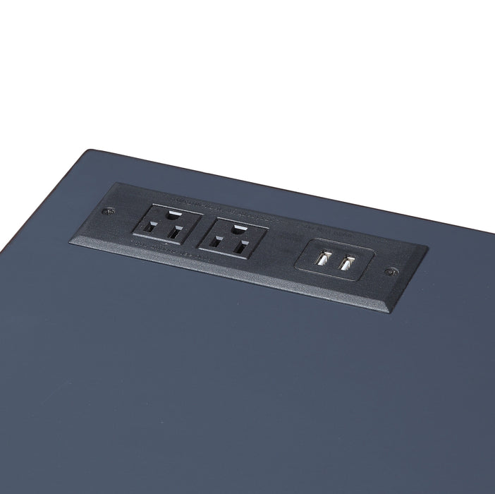 Detailed shot of two power outlets and USB ports on one corner of the blue desktop.
