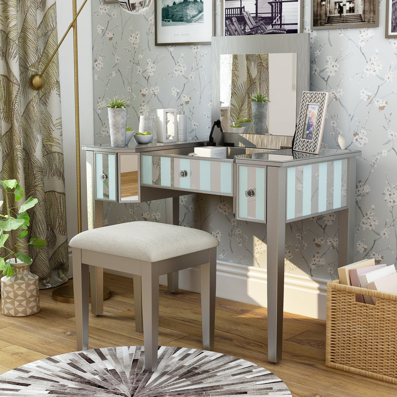 Left-angled silver vanity set in a bedroom.