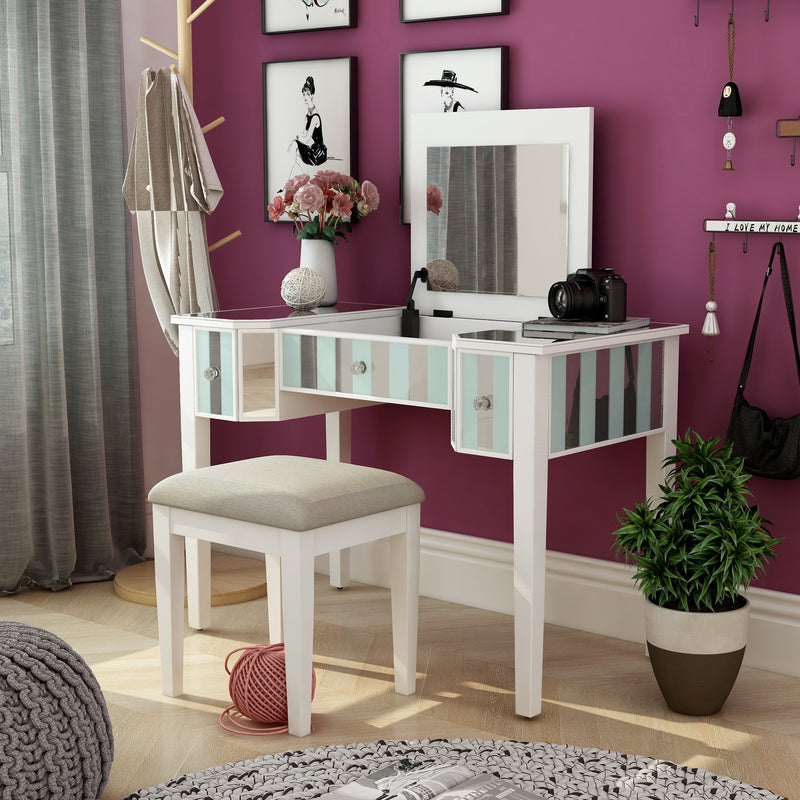Left-angled white vanity set in a bedroom. Pink flowers, a camera, and a notebook adorn the vanity table as the white set mingles with the magenta wall it sits against.