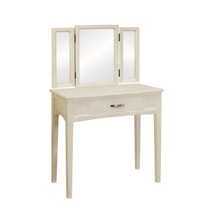 Right-angled white vanity table against a white background. A tri-fold mirror and drawer with silver bar pull sit on tapered legs.