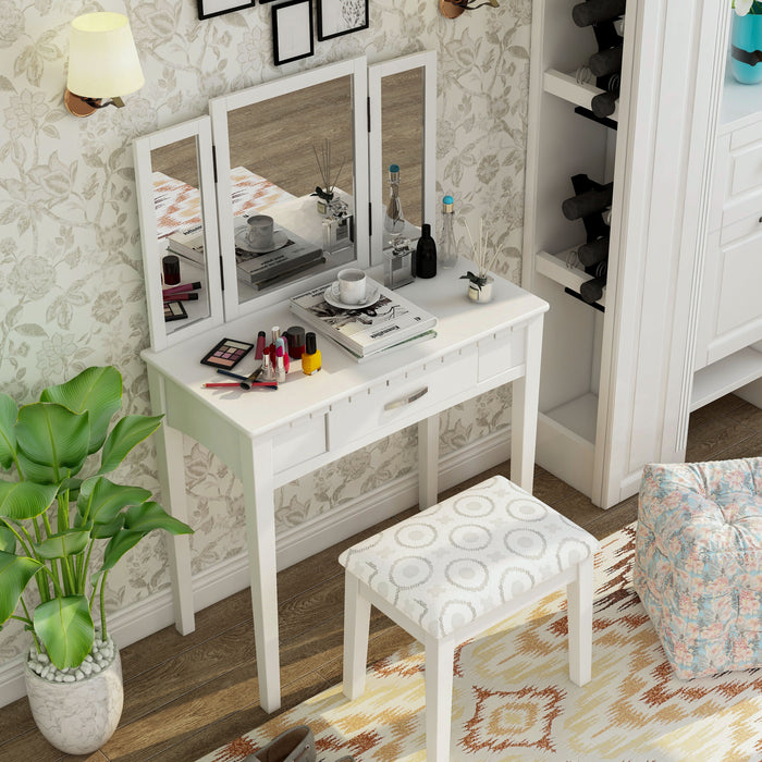Top view of a white vanity set in a traditional bedroom. Make-up, incense, and a cup of coffee sit on the tabletop.