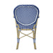 Backside of a blue patio bistro armchair against a white background.