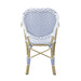 Backside of a white patio bistro armchair against a white background.