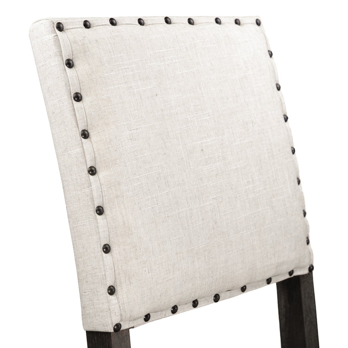 Right-angled detail shot of the beige fabric square chair back with nailhead trim.
