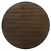 Top view of a dark walnut round dining table against a white background.