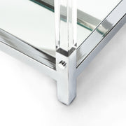 Left angled close-up view of mirror shelves in acrylic and chrome steel frame with rivets on modern sofa table on a white background