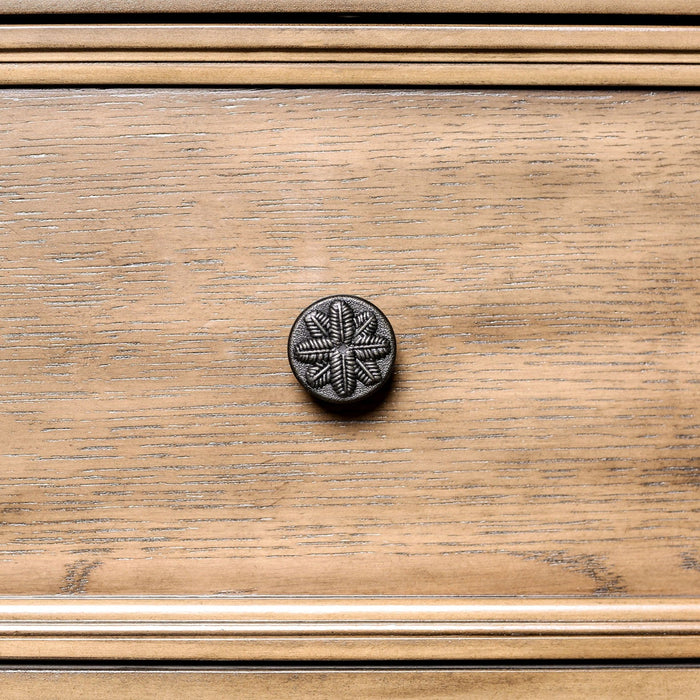 Detailed shot of the knob pull with a flora design.