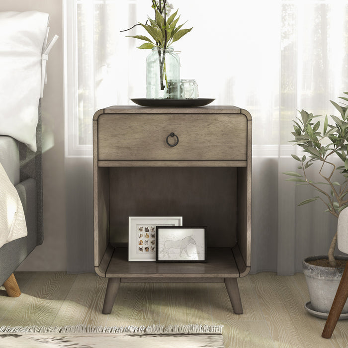 Front-facing mid-century modern one-drawer gray wood side table in a bedroom with accessories.