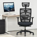 Front-facing contemporary black adjustable office chair with headrest in an office with accessories