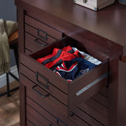 Top view six-drawer wood dresser with upper drawer open on a wood floor