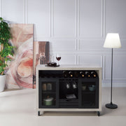 Straight-facing cement and black wine bar cabinet against a white background. The 10 slots beneath the tabletop hold wine bottles, while the 3 stemware racks hang wine glasses. A plank-style drawer is flanked by wire-mesh cabinets. The entire buffet sits on wheels with parking brakes.