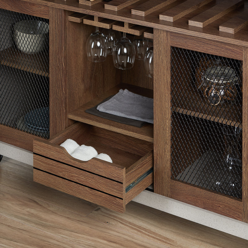 Right-angled cement and distressed walnut wine bar cabinet against a white background. The 10 slots beneath the tabletop hold wine bottles, while the 3 stemware racks hang wine glasses. A plank-style drawer is flanked by wire-mesh cabinets. The entire buffet sits on wheels with parking brakes.