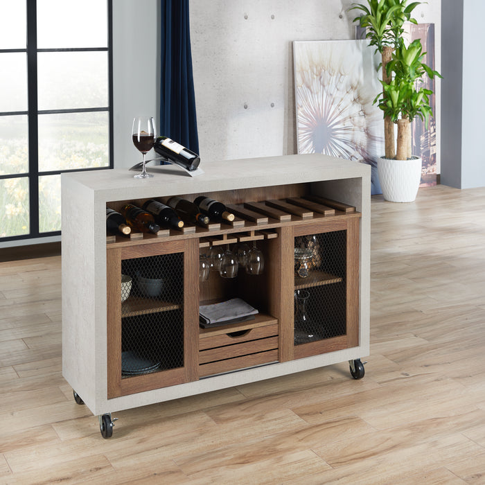 Right-angled cement and distressed walnut wine bar cabinet against a white background. The 10 slots beneath the tabletop hold wine bottles, while the 3 stemware racks hang wine glasses. A plank-style drawer is flanked by wire-mesh cabinets. The entire buffet sits on wheels with parking brakes.