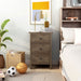 Front-facing three-drawer nightstand in a distressed walnut finish in a bedroom with accessories