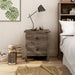 Front-facing two-drawer nightstand in a distressed walnut finish in a bedroom with accessories