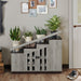 Front-facing rustic four-door stair-step storage cabinet in vintage gray oak in an entryway with accessories