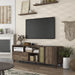 Left angled rustic three-shelf TV stand in reclaimed oak in a living room with accessories