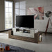 Left angled rustic faux concrete and reclaimed oak TV stand in a living room with accessories