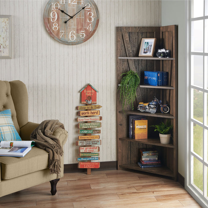 Left angled rustic reclaimed oak five-shelf corner bookcase in a sitting area with accessories