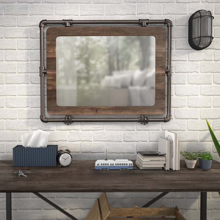 Front-facing industrial wood and pipe frame wall mirror over a console in a farmhouse living space