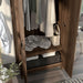 Right-angled close up top view tall, distressed walnut wardrobe cabinet with two open doors in a casual bedroom with accessories