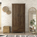 Front-facing tall wardrobe cabinet with one drawer and two doors in a medium distressed walnut finish in a casual bedroom