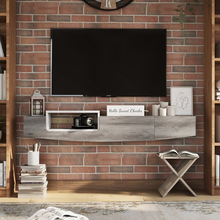 Front-facing vintage grey oak wall-mounted TV console in a living room. A TV is mounted just above the console.
