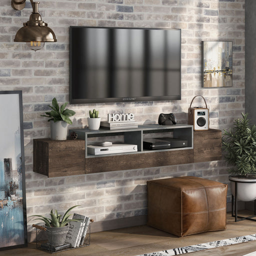Right-angled reclaimed oak wall-mounted TV console in an urban living room. A chicken wire basket of books and a cognac leather ottoman sit under the floating TV console. A VCR, stereo, x-box, and controller sit on its open shelves. A TV is mounted just above the console.