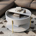 Left angled top view of a modern round white storage coffee table with its sliding top open in a living area with accessories