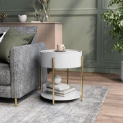 Left angled modern round white storage end table with a sliding top in a living area with accessories