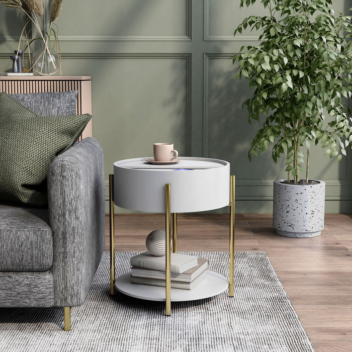 Front-facing modern round white storage end table with a sliding top in a living area with accessories