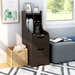Right angled contemporary walnut two-drawer tall nightstand in a sitting area with accessories