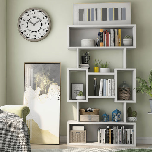 Front-facing contemporary white bookcase filled with books and decor in an eclectic living room setting.