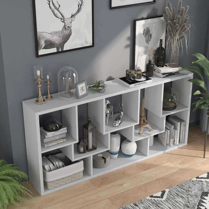 Right angled top view modern white geometric bookcase with staggered shelves laid horizontally in a sitting area with accessories