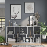 Front-facing modern white geometric bookcase with staggered shelves laid horizontally in a living area with accessories