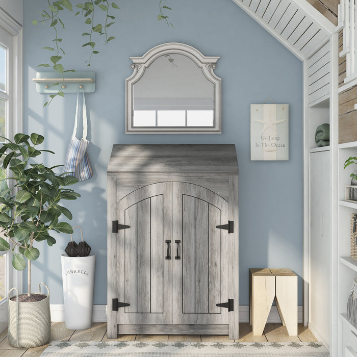 Front-facing transitional vintage gray oak shoe cabinet with adjustable shelves and flip top shelf in a modern farmhouse mudroom with mirror. Rustic black door pulls and black hinges.