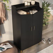 Right-angled modern black shoe cabinet with open upper shelf in foyer with books, candles, and picture frames.