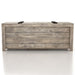 Front-facing rustic weathered oak storage bench with a sliding top on a white background