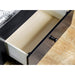 Right angled top view close up cottage style black daybed open drawer detail in a living space