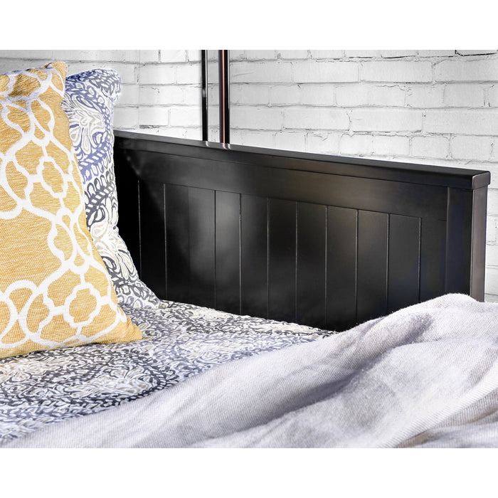 Right angled close up cottage style black daybed with three drawers inner side detail in a living space with linens and accessories