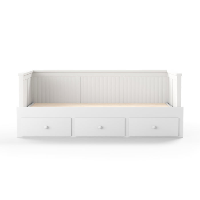Front-facing cottage style white daybed with three drawers on a white background
