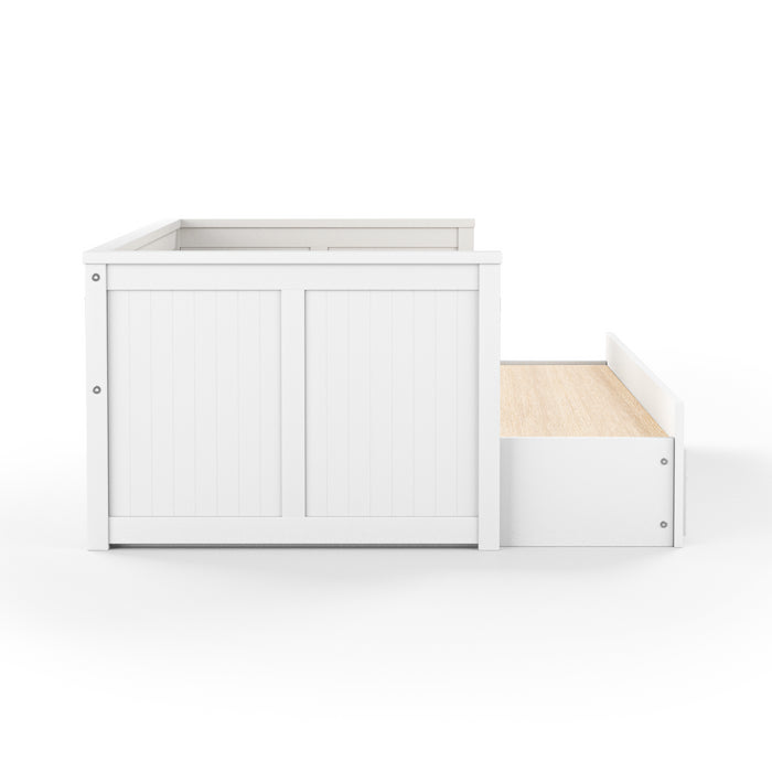 Front-facing side view cottage style white daybed with three drawers and white linens on a white background