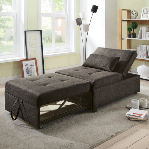 Right angled transitional dark gray fabric convertible ottoman opened to a futon bed in a living room with accessories