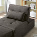 Right angled close up transitional dark gray fabric convertible ottoman opened to a futon bed in a living room with accessories