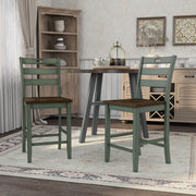 Antique green ladderback counter height chair against a white background.