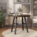 Front-facing rustic wood drop-leaf dining table with a wood finish top and colored base in a casual breakfast nook with accessories