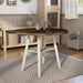 Right-angled rustic wood drop-leaf dining table with a wood finish top and white base in a casual breakfast nook with accessories