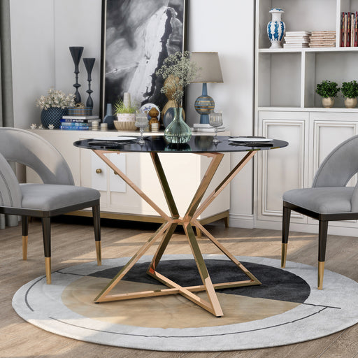 Left-angled modern glam dining table with a two-tone black and gold finish and bold, geometric base in a contemporary dining room with accessories