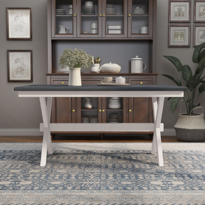 Front-facing contemporary antique white and gray dining table with an X-cross base in a dining room with accessories